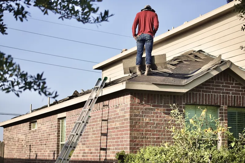 Professional roofer working on a residential roof in Jacinto City